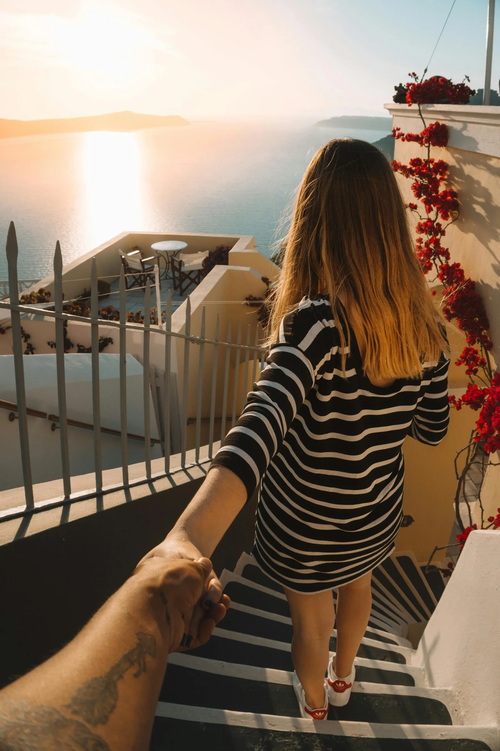 Woman Wearing White and Black Striped Long-sleeved Shirt Standing on Stairs